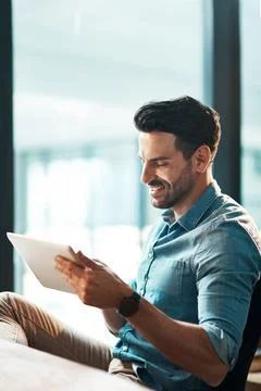 Simplifying any work task with smart apps. a young businessman using a digital Stock Photos