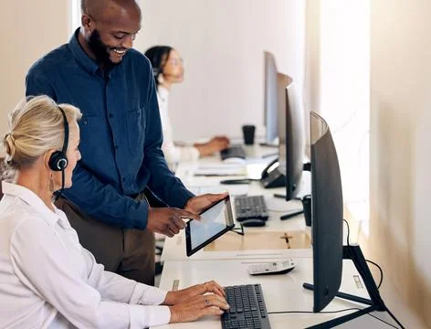Simplifying processes to the right solutions. Shot of two call centre agents  Stock Photos