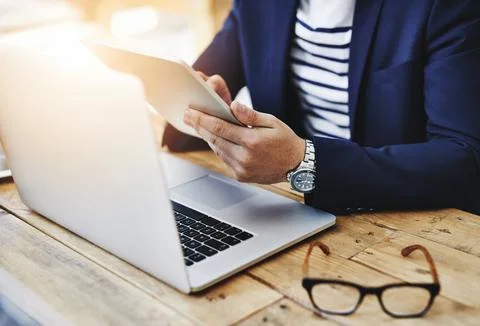 Simplifying the work task with smart technology. a businessman using a digital Stock Photos