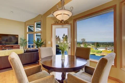 Simplistic dinning area with great view, and light toned hardwood floor. Stock Photos