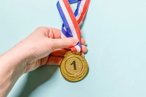 Simply flat lay design hand holding winner or champion gold trophy medal is.. Stock Photos