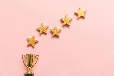 Simply flat lay design winner or champion gold trophy cup and 5 stars ratin.. Stock Photos