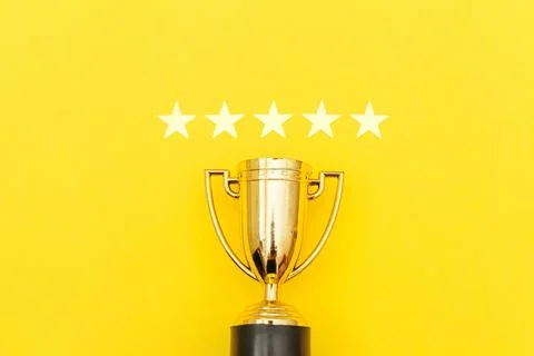 Simply flat lay design winner or champion gold trophy cup and 5 stars ratin.. Stock Photos