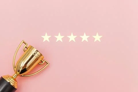 Simply flat lay design winner or champion gold trophy cup and 5 stars ratin.. Stock Photos
