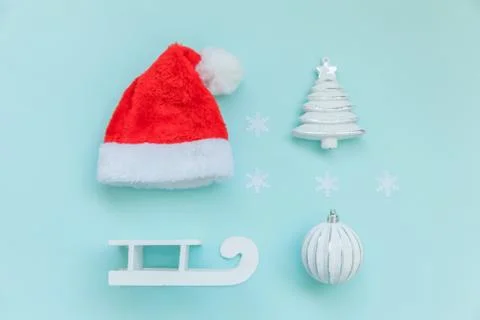 Simply minimal composition winter objects ornament Santa hat sled fir tree ba Stock Photos