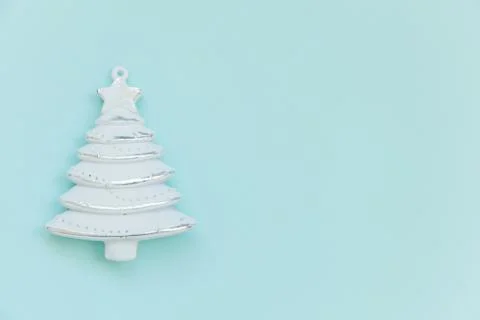 Simply minimal composition winter objects ornament fir tree isolated on blue  Stock Photos