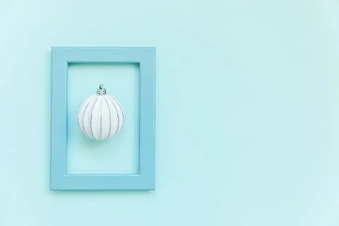 Simply minimal composition winter objects ornament ball in blue frame isolate Stock Photos
