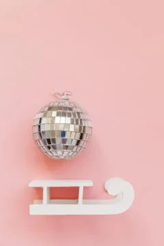 Simply minimal composition winter objects ornament ball sled isolated on pink Stock Photos