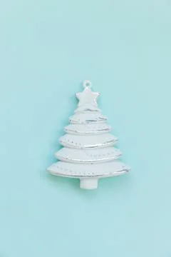 Simply minimal composition winter objects ornament fir tree isolated on blue  Stock Photos