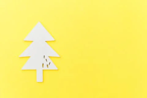 Simply minimal composition winter objects ornament fir tree isolated on yello Stock Photos