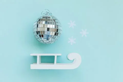Simply minimal composition winter objects ornament ball sled isolated on blue Stock Photos