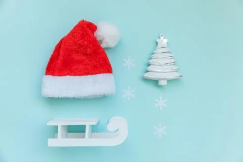 Simply minimal composition winter objects ornament Santa hat sled fir tree Stock Photos
