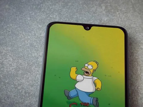 The Simpsons Tapped Out app launch screen on smartphone on ceramic stone ba.. Stock Photos