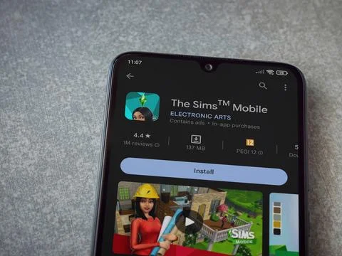 The Sims Mobile app play store page on smartphone on ceramic stone background Stock Photos