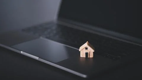 A simulated house on a laptop computer. Stock Photos