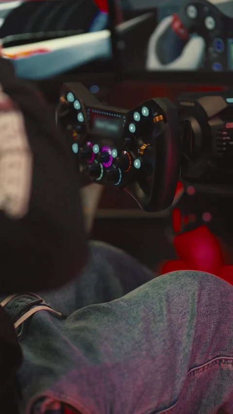 Simulation racing game setup in an arcade with a focus on driving controls and 库存影片 338242837