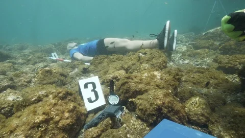 Simulation of underwater crime diver measures the gun length,Ustica,Med sea Stock-Footage 124343386