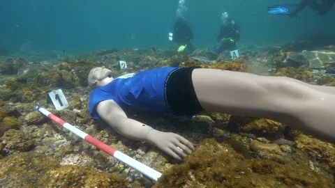 Simulation of an underwater crime scene, divers near the dummy, Ustica, Med sea Stock Footage 124055857