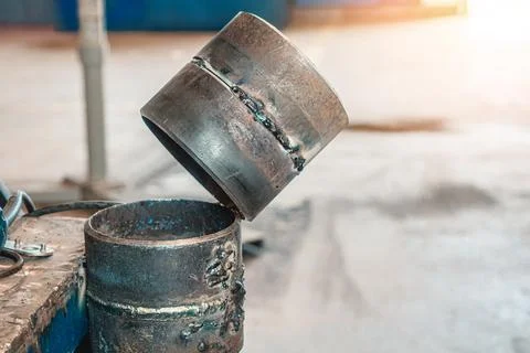 Simulator for practicing welding of metal pipes. Welded seam on metal rings. Stock Photos