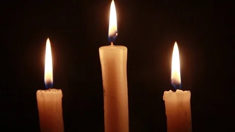 Simultaneous attenuation of three candles Stock Footage 84575450