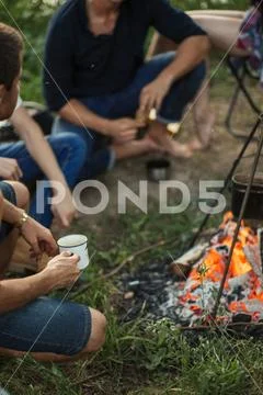 Sincere and spiritual conversation near campfire Stock Photos