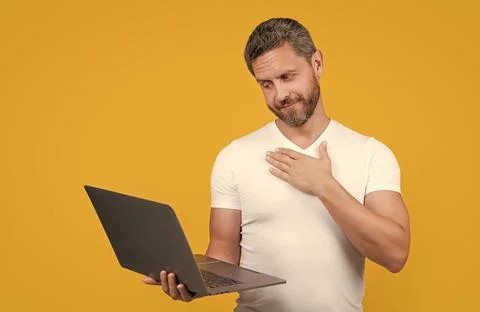 Sincerely man programmer in studio. man programmer with laptop isolated on 스톡 사진