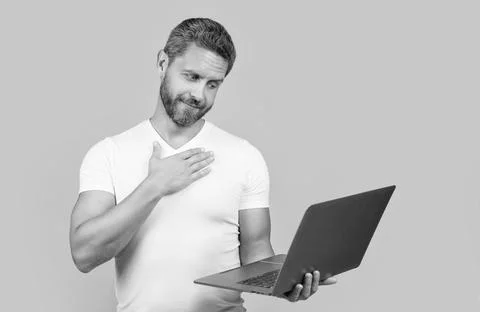 Sincerely man programmer in studio. man programmer with laptop isolated on 스톡 사진