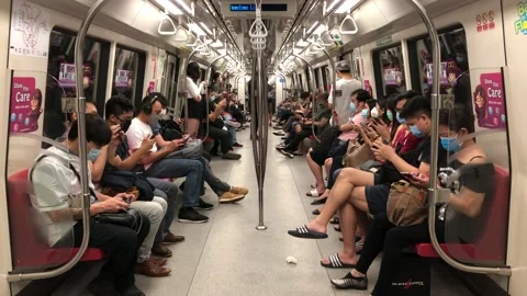 Singapore: Commuters on a MRT train amid Covid-19, 4K Stock Footage 140393059