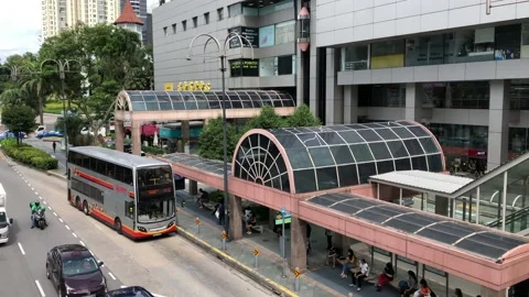 Singapore: Elevated view of a public bus at bus stop and city traffic, 4K Stock Footage 165060680