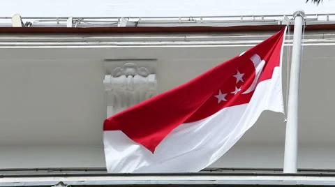 Singapore flag waves in wind from flagpole on top of buliding 動画素材 47792840