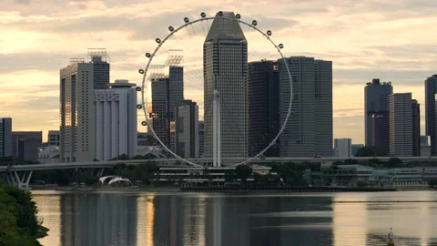 Singapore flyer and skyline druing sunset Stock Footage 136809953
