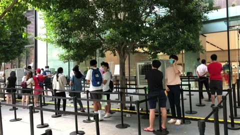 Singapore: People queue in front of an Apple Store on Orchard Road, 4K Stock Footage 134589802