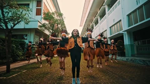 Singer and Tribal Dancers Performing Energetic Choreography Stock Footage 263237456