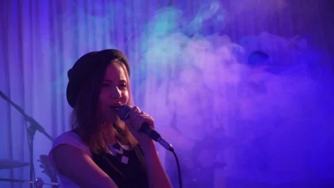 A singer with a black hat stands at the bottom of the birth. Performance rock Stock Footage 82516902