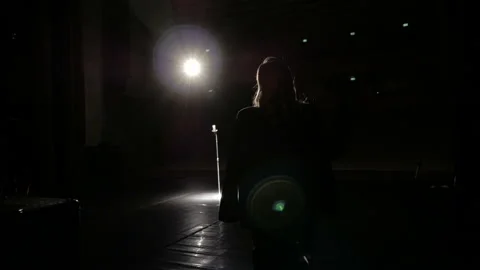 The singer on a dark stage in a beam of light. Stock Footage 162377416
