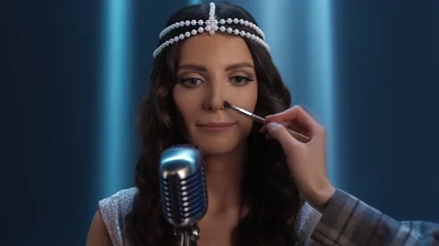 The singer gets makeup. The make-up artist's hand corrects the make-up. Stock-Footage 170372111