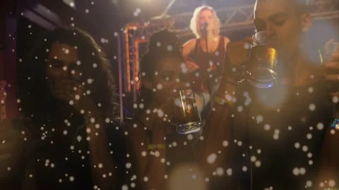 Singer opening chorus at gig causing group lifting mugs and sipping, lights and Stock Footage 332469416