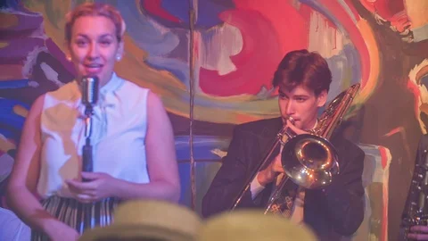 Singer passionately and a man on trombone is accompanying her Stock Footage 112196350