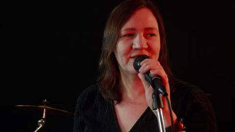 Singer performing with microphone in music studio Stock Footage 295795988