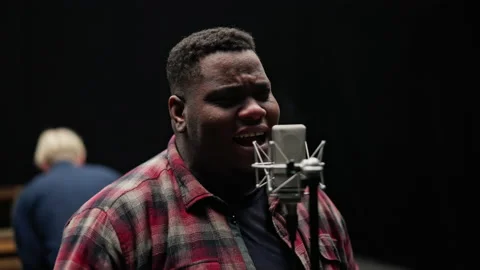 Singer Performing Passionately In A Studio Stockbeeldmateriaal 236512730