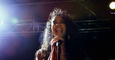 Singer performing on stage at a concert 4k Stockbeeldmateriaal 80010053