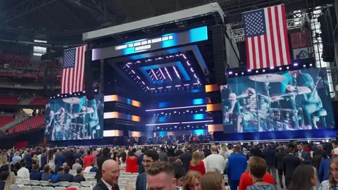 A singer performs on the video wall above the stage at the Charlie Kirk memorial Stock-Footage 345297838