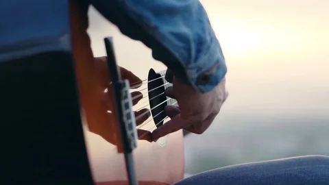Singer playing the guitar at sunset on the mountain Stock Footage 112156705