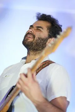 Singer plays the guitar while feeling the music inside Stock Photos