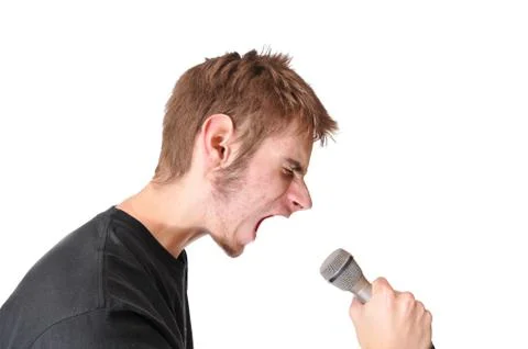 A singer screaming into a microphone isolated on white background Foto stock