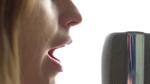 Singer singing into microphone. Close-up shot Stock Footage 73754960