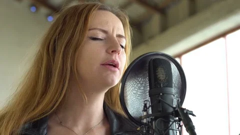Singer singing into a microphone in the studio. Close-up shot Stock Footage 73755024