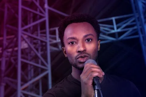 Singer on stage music performance live show pop rock karaoke man holding micr Stock Photos