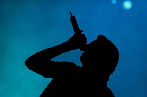 Singer on stage silhouetted Stock Illustration