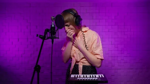 The singer is trying to sing, her throat hurts, a cough appears Stock Footage 167475368